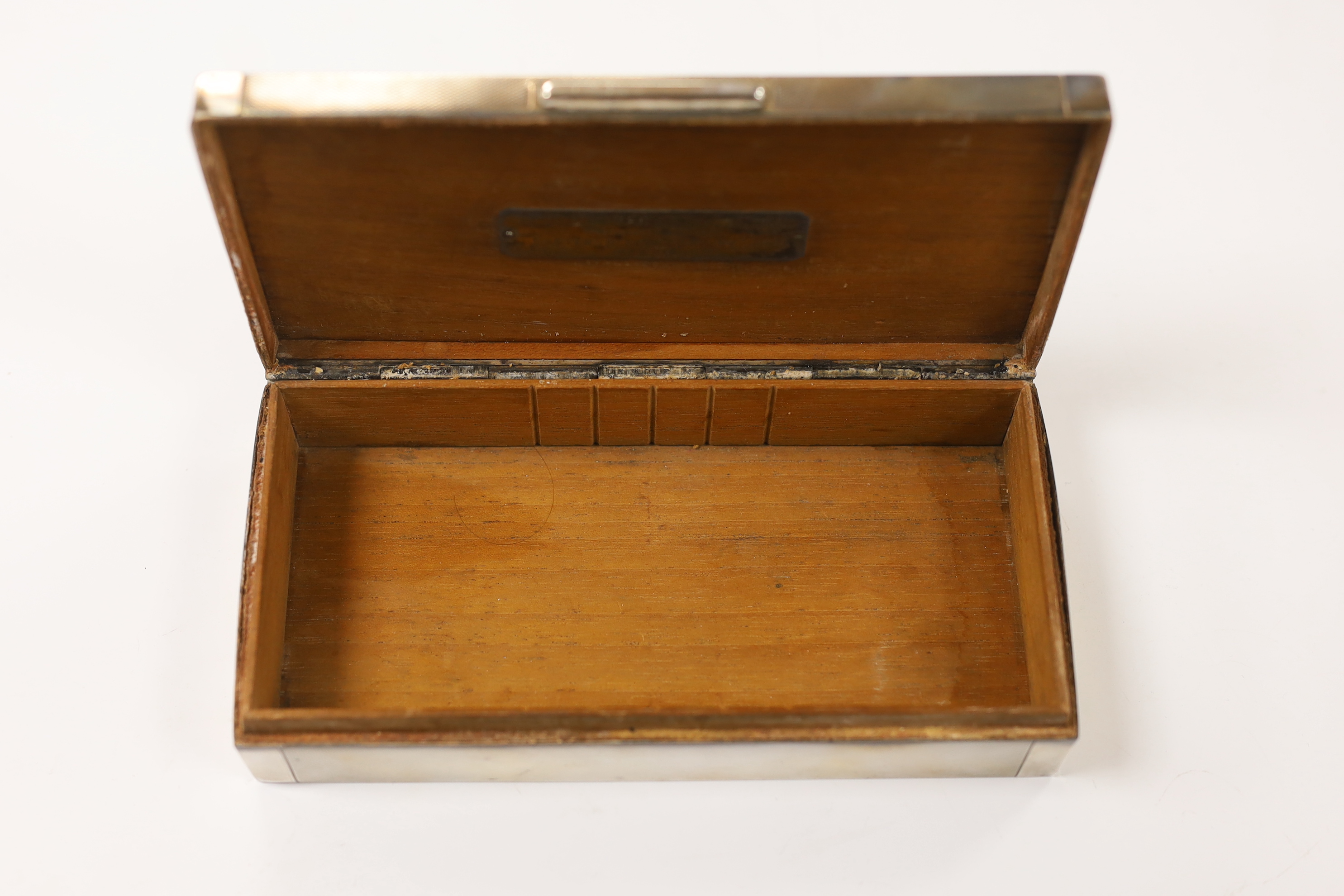 A George VI part engine tuned silver mounted rectangular cigarette box, with white metal crocodile surmount and interior presentation inscription relating to 'Lt. Colonel K.F.G. Stronach', maker Hamilton & Co, London, 19